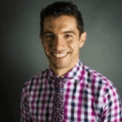 A person wearing a pink plaid shirt with a pink tie.